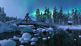 Catch the northern lights on a husky safari in Harriniva, Finland.