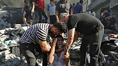 Palestinians comfort a crying man after losing relatives under the rubble of a destroyed house following an Israeli airstrike in Gaza City, Saturday, Nov. 4, 2023.