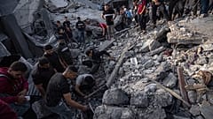 فلسطينيون يبحثون عن ناجين من القصف الإسرائيلي على مخيم المغازي للاجئين بقطاع غزة، الأحد 5 نوفمبر/تشرين الثاني 2023