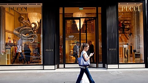 Picture showing a woman in front of an Emilio Pucci's boutique situated along Avenue Montaigne in Paris. 