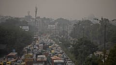  A pedestrian walks on a bridge above vehicle traffic in New Delhi, India