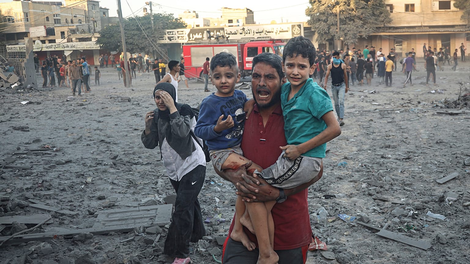 Palestinian walk away after Israeli airstrike in Rafah, Gaza Strip, Tuesday, Nov. 7, 2023. 