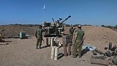 Israeli soldiers fire artillery into Gaza