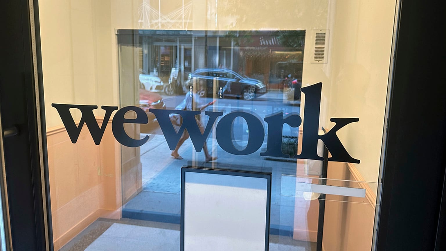 A sign for WeWork is displayed at their office in the borough of Manhattan in New York, Aug. 9, 2023.