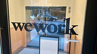 A sign for WeWork is displayed at their office in the borough of Manhattan in New York, Aug. 9, 2023.