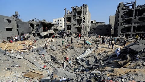 Palestinians wander among debris of buildings that were targeted by Israeli airstrikes in Jabaliya refugee camp, northern Gaza Strip, Wednesday, Nov. 1, 2023. 