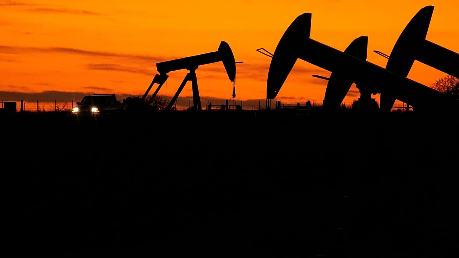 Oil Pump jacks work at dusk near Barnes City, Texas, Wednesday, 1 November 2023. 