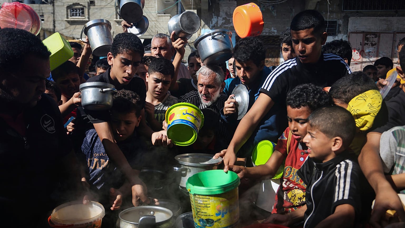 Palestinians crowded together as they wait for food distribution in Rafah, southern Gaza Strip, Wednesday, Nov. 8, 2023.