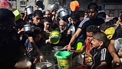 Palestinians crowded together as they wait for food distribution in Rafah, southern Gaza Strip, Wednesday, Nov. 8, 2023.
