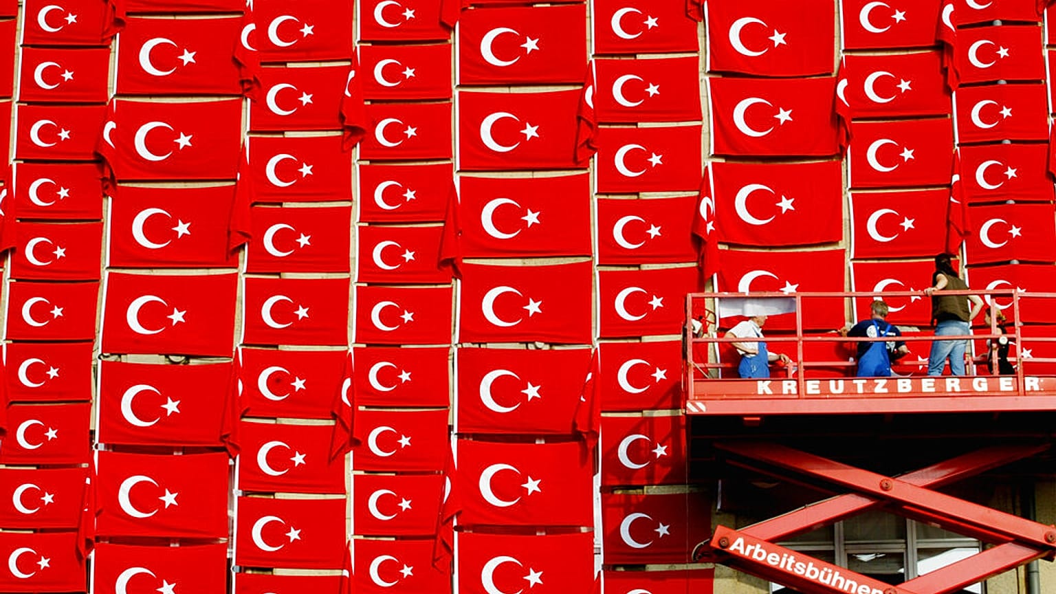 FILE - Workers attach flags with the national symbol of Turkey to the outside wall of the Kunsthalle in Kiel on Tuesday, August 19, 2003.