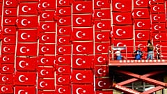FILE - Workers attach flags with the national symbol of Turkey to the outside wall of the Kunsthalle in Kiel on Tuesday, August 19, 2003.