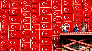 FILE - Workers attach flags with the national symbol of Turkey to the outside wall of the Kunsthalle in Kiel on Tuesday, August 19, 2003.