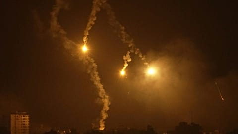 Wide shot huge fireballs erupt in northern Gaza seen from Israel.