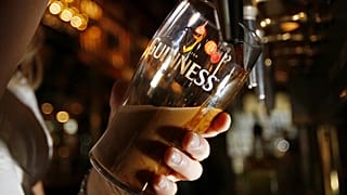 Pinte of Guinness beer being poured.