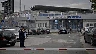 Kosovo police officer stands guard near the Fadil Vokrri stadium, in Pristina on November 10, 2023