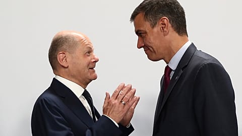 In this photo provided by the Spanish government, Germany's Chancellor Olaf Scholz, left, speaks with Spain's acting Prime Minister Pedro Sanchez at the Europe Summit in Grana