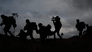 A journalist runs with Ukrainian infantrymen during a training with French soldiers, in France, Tuesday, Nov. 7, 2023.