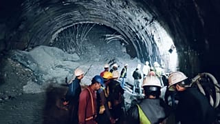 Rescuers inside a collapsed road tunnel where more than 30 workers were trapped by a landslide in northern in Uttarakhand state, India