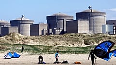Kite surfers in front of the Gravelines nuclear plant near Dunkirk, northern France. April 18, 2015.