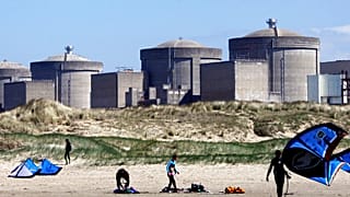 Kite surfers in front of the Gravelines nuclear plant near Dunkirk, northern France. April 18, 2015.