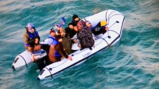 FILE: Migrants aboard a rubber boat being intercepted by French authorities, off the port of Calais, northern France, 25 December 2018