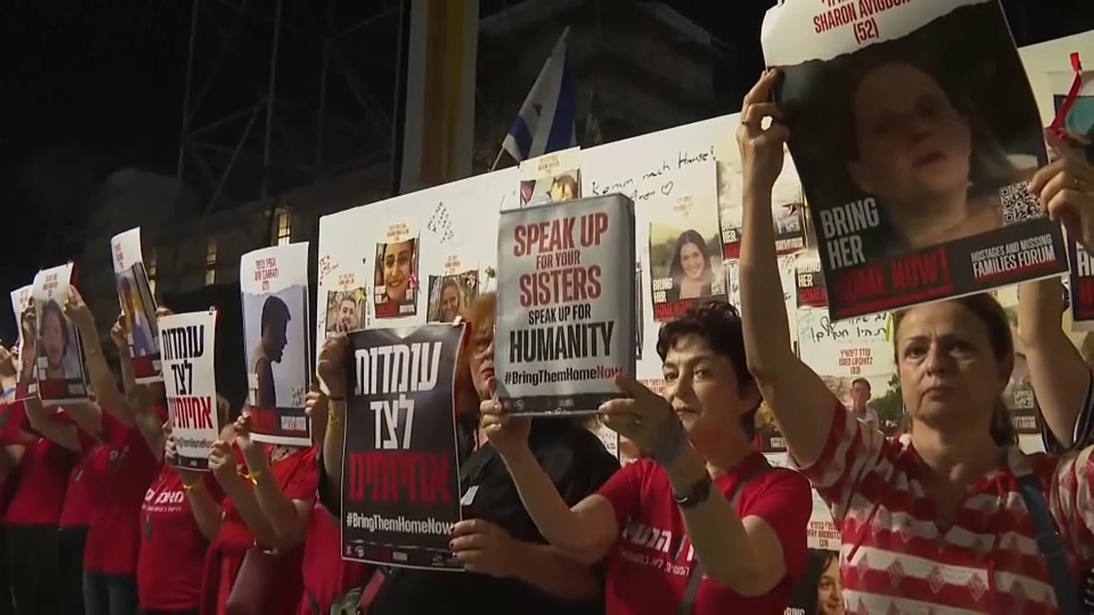 Various pictures of women holding pictures of hostages held by Hamas.