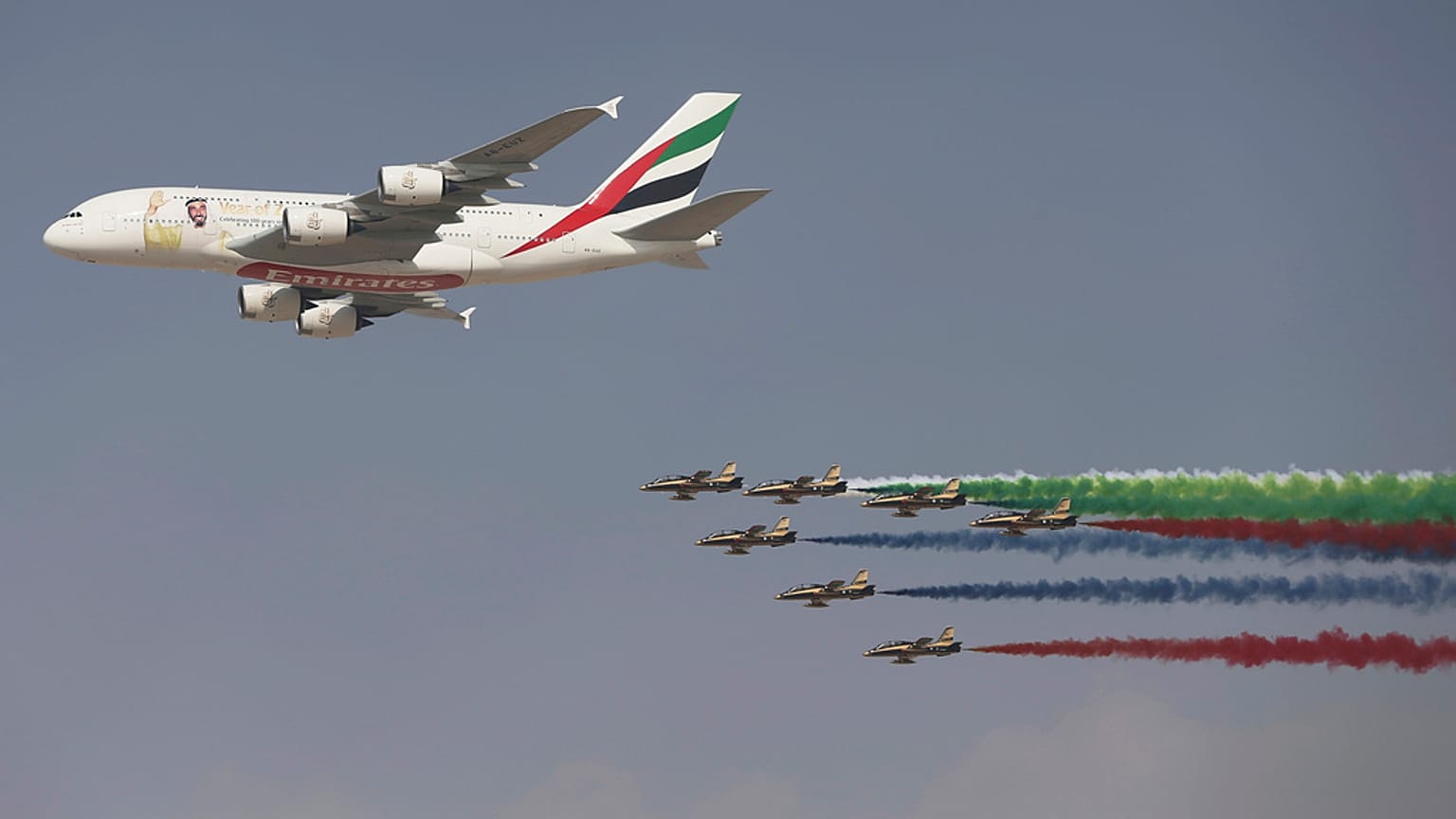 An Emirates Airline A-380 leads the "Al Fursan", or the Knights, a UAE Air Force aerobatic display team, during the opening day of the Dubai Air Show on Nov. 12, 2017.