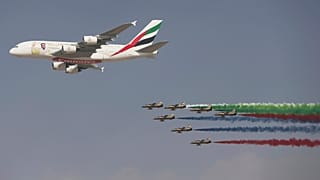 An Emirates Airline A-380 leads the "Al Fursan", or the Knights, a UAE Air Force aerobatic display team, during the opening day of the Dubai Air Show on Nov. 12, 2017.
