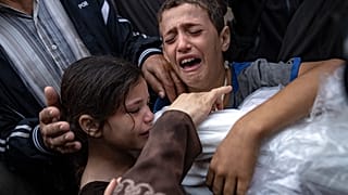 Palestinians mourn their relatives killed in the Israeli bombardment of the Gaza Strip, in the hospital in Khan Younis, Tuesday, Nov. 14, 2023. 