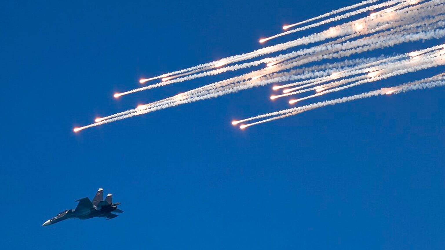 FILE - A Russian fighter jet flies during a rehearsal of the Russian Navy Day parade in Sevastopol, Crimea, Friday, July 24, 2015.