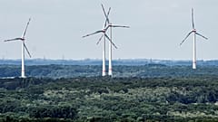 Wind turbines produce power as they turn at the green outskirts of Bottrop, Germany, in June.