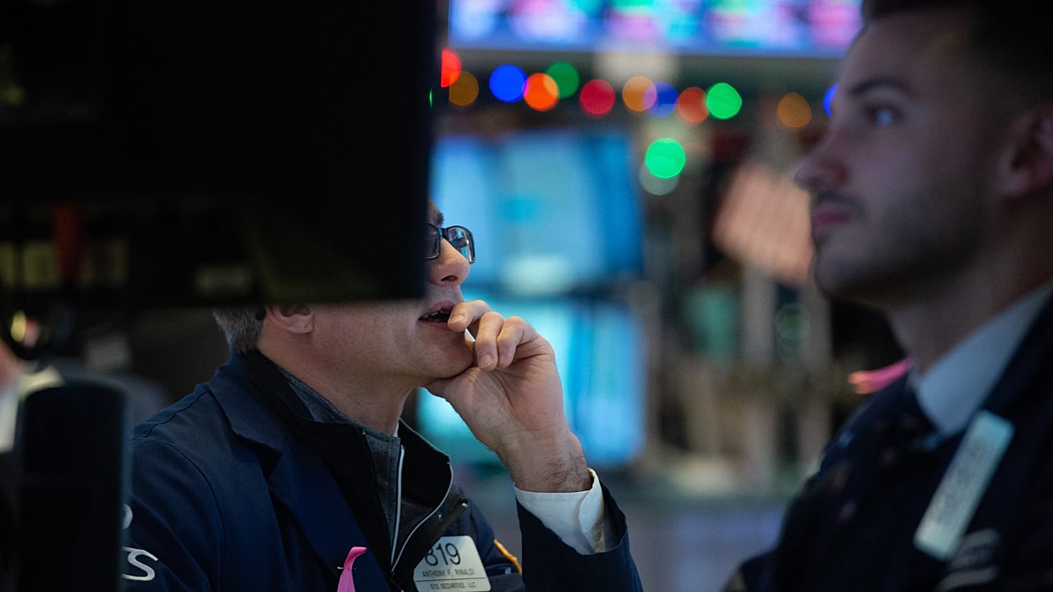 Traders work on the floor of the Dow Industrial Average at the New York Stock Exchange 