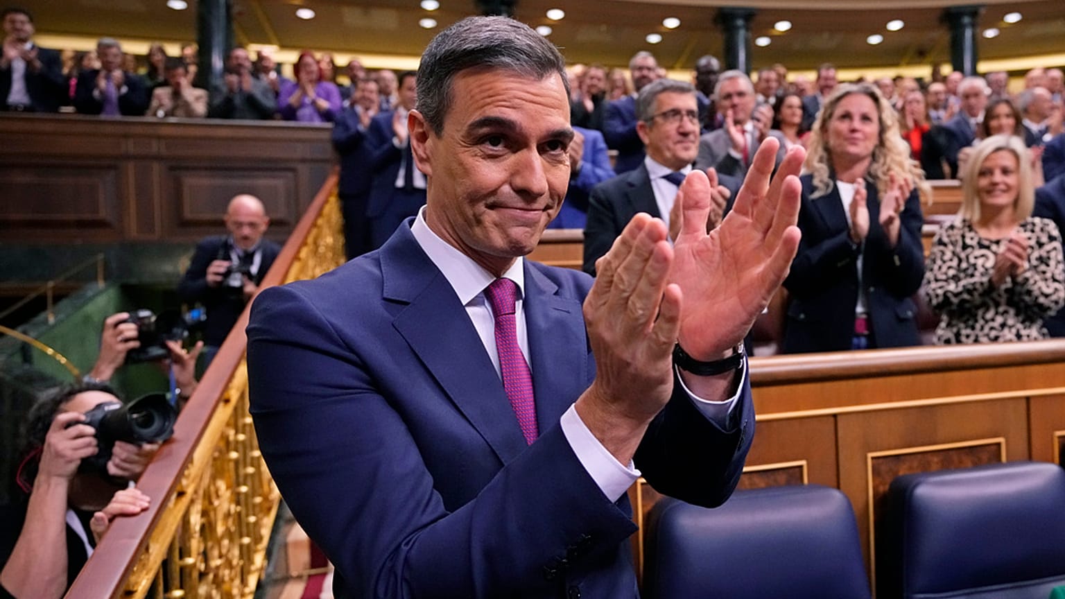 Spain's acting Prime Minister Pedro Sanchez applauds at the start of the investiture debate at the Spanish Parliament in Madrid, Spain, Wednesday, Nov. 15, 2023.