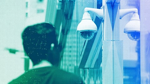 A man walks near a security camera, July 2019