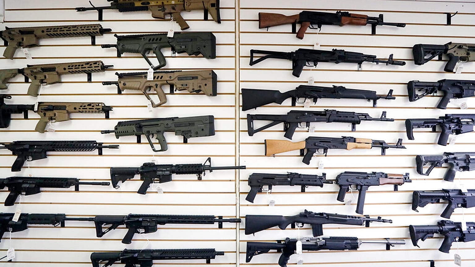 FILE - In this photo taken Oct. 2, 2018, semi-automatic rifles fill a wall at a gun shop in Lynnwood in the United States.