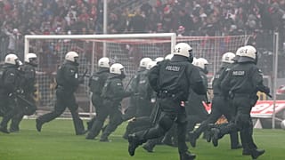 German riot police chase Cologne soccer supporters