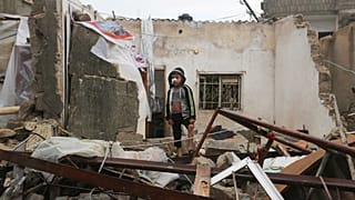 A Palestinian boy stands among the destruction after Israeli strikes on Rafah, Gaza Strip