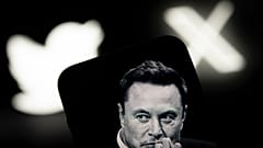 An image of Elon Musk is seen displayed on a mobile device with the Twitter and X logos in this illustration photo 