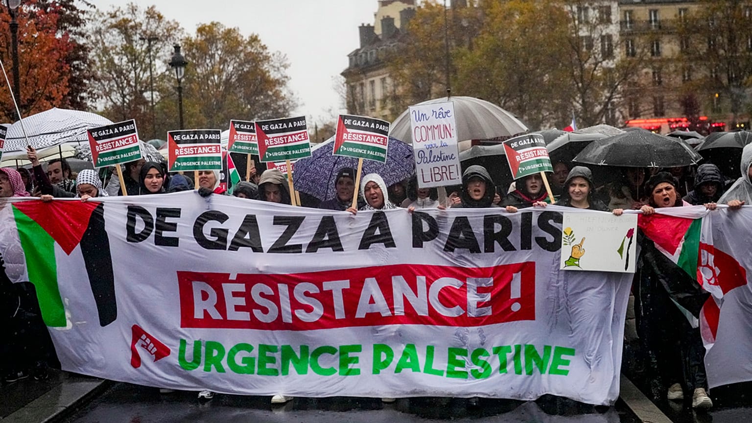 People chant slogans holding banners that reads "From Gaza to Paris - Residence - Emergency Palestine" during a pro-Palestinian rally, in Paris, Saturday, Nov. 18, 2023.