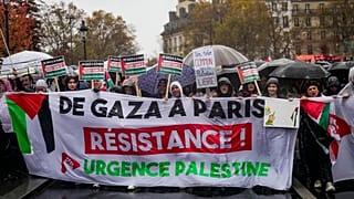 People chant slogans holding banners that reads "From Gaza to Paris - Residence - Emergency Palestine" during a pro-Palestinian rally, in Paris, Saturday, Nov. 18, 2023.