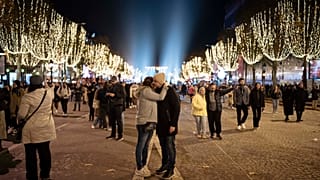 Una pareja en la inauguración de las luces navideñas en los Campos Eliseos en París, el domingo 19 de noviembre de 2023.
