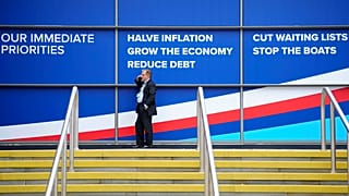 A party member speaks on the phone as he waits for the opening of the Conservative Party annual conference in Manchester, England, on 4 October.