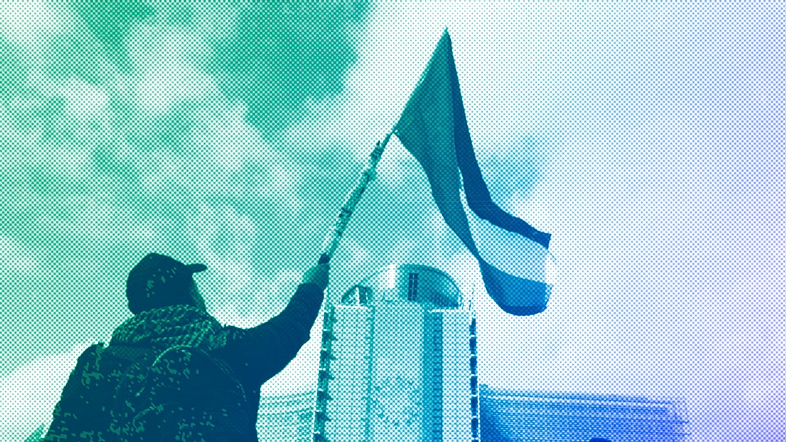 Protestors wave flags as they march past EU institutions during a demonstration in Brussels, in solidarity with the Palestinian people in Gaza, October 2023