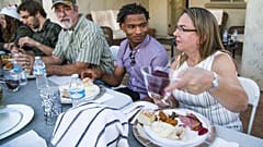 Jamal Hinton, centre, Wanda Dench, right, and her family and friends, have Thanksgiving dinner at Dench's home on 24 November 2016, in Mesa, Arizona.