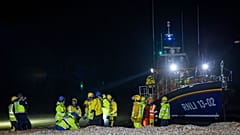 Asylum seekers arrive at Dungeness beach, south east England, on Wednesday 