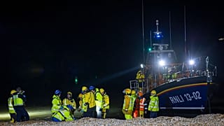 Asylum seekers arrive at Dungeness beach, south east England, on Wednesday 