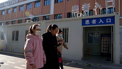 Visitors pass by the children's hospital in Beijing in November 2023. 
