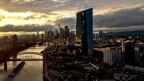 The sun sets over the buildings of the banking district and the European Central Bank, right, in Frankfurt, Germany, Friday, Oct. 20, 2023