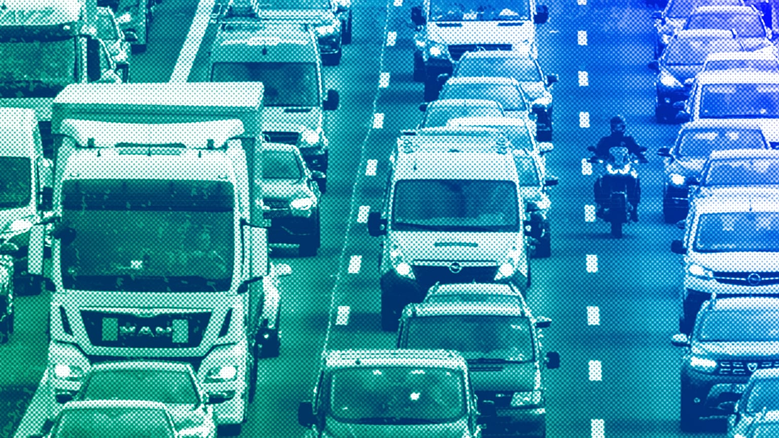 Trucks, cars and a biker drive on a highway in Frankfurt, February 204