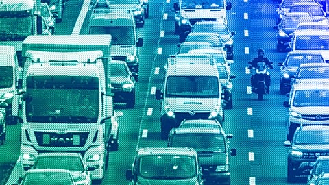Trucks, cars and a biker drive on a highway in Frankfurt, February 204